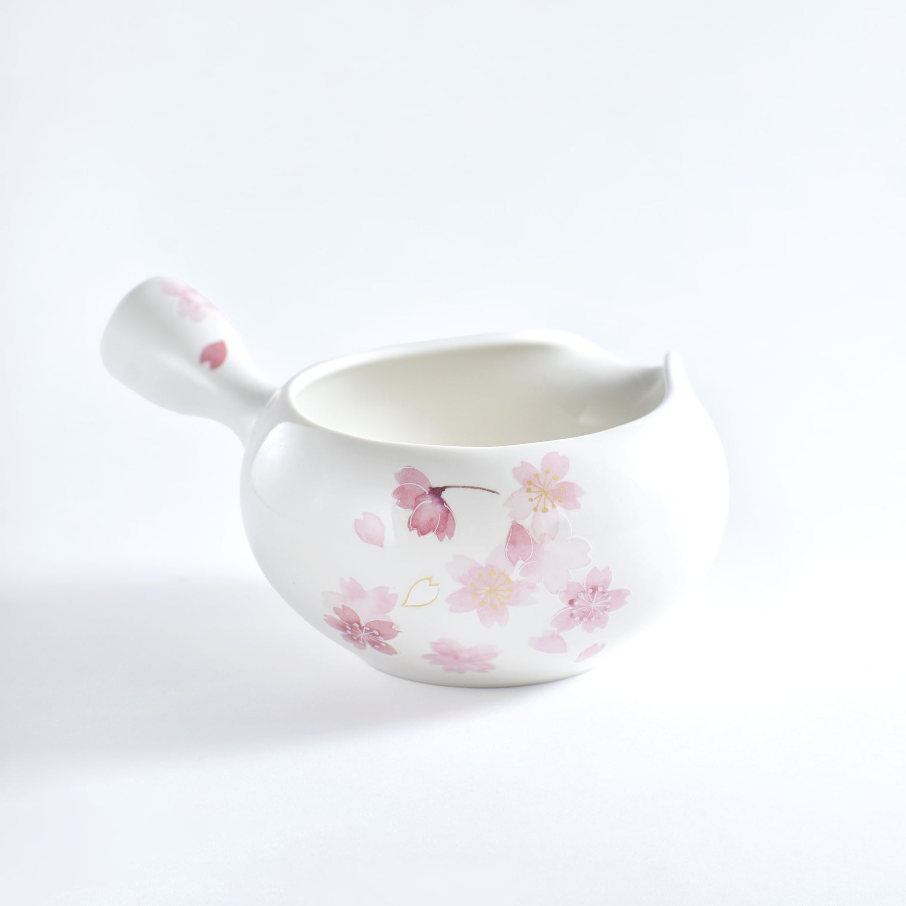 Ceramic ladle with floral design on a white background