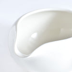 Close-up of a white ceramic bowl on a light gray background