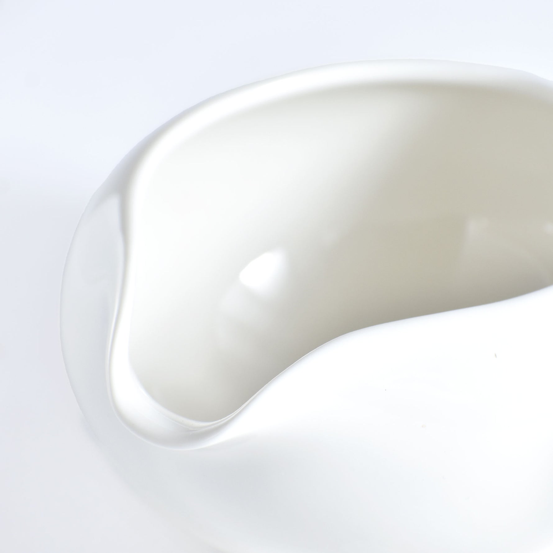Close-up of a white ceramic bowl on a light gray background
