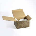 Open cardboard box with floral pattern on a white background