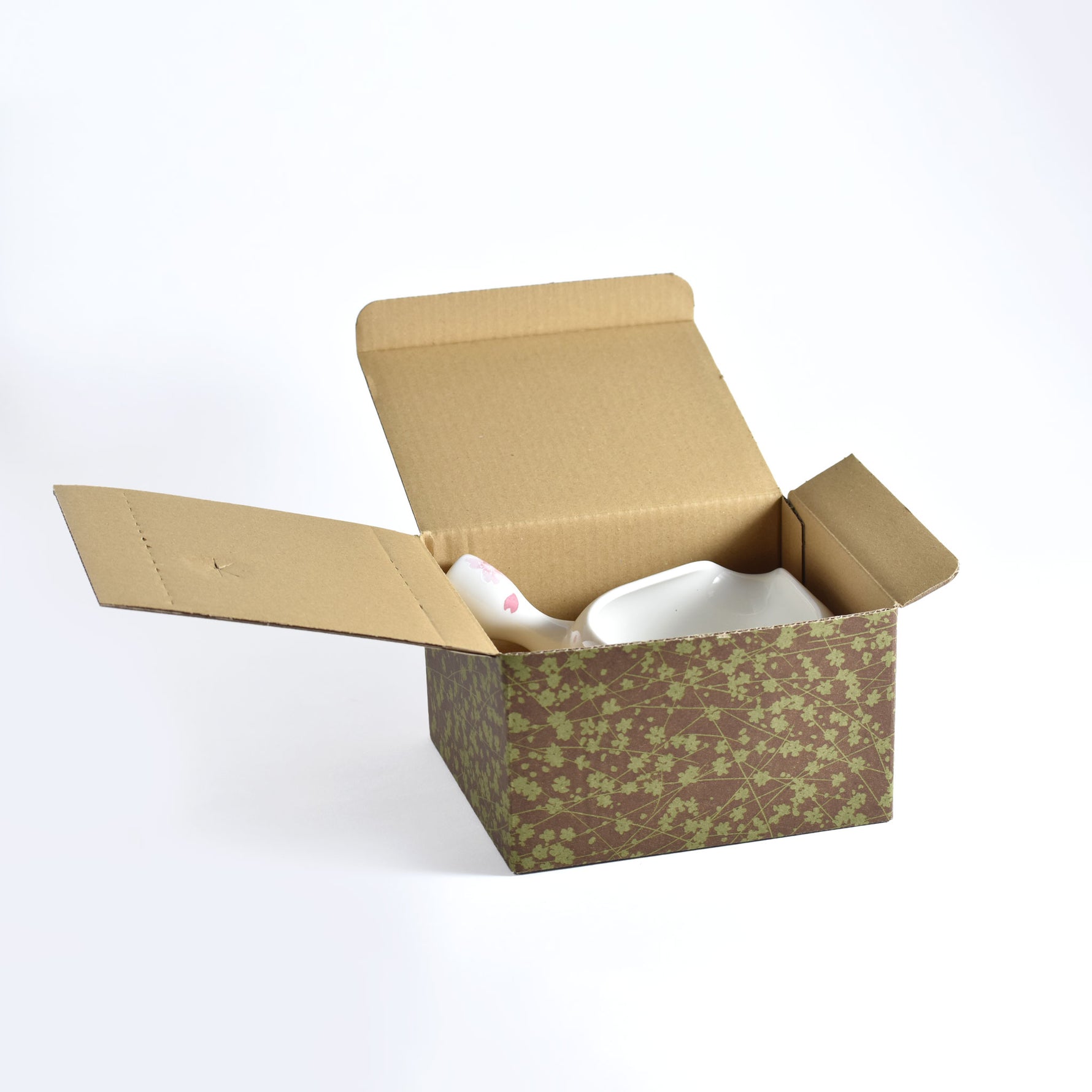Open cardboard box with floral pattern on a white background
