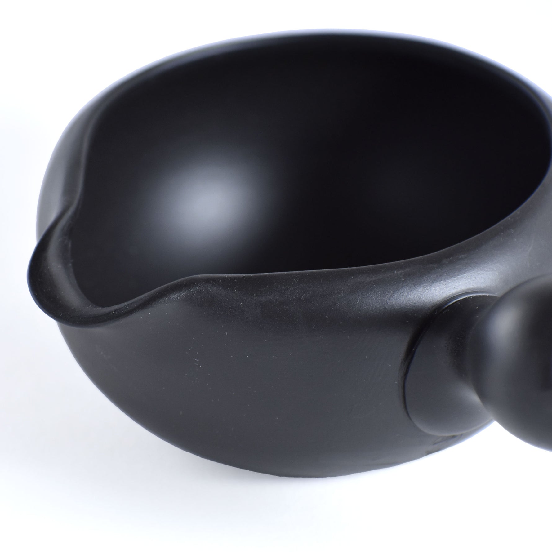 Black ceramic teapot on a white background