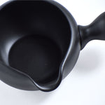 Black ceramic teapot on a white background