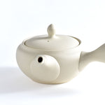 White ceramic teapot on a white background