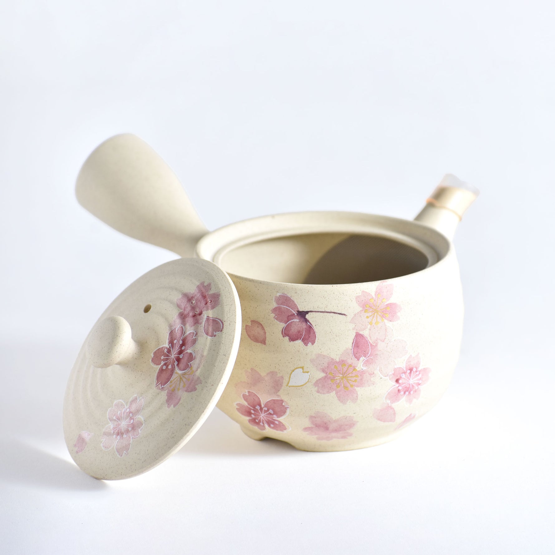 Ceramic pot with floral design on a white background