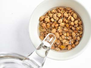 Glass teapot with natto in a white bowl on a light background
