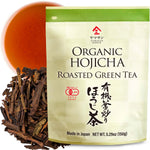 YamaSan Organic Hojicha roasted green tea package with tea leaves and a cup of tea.