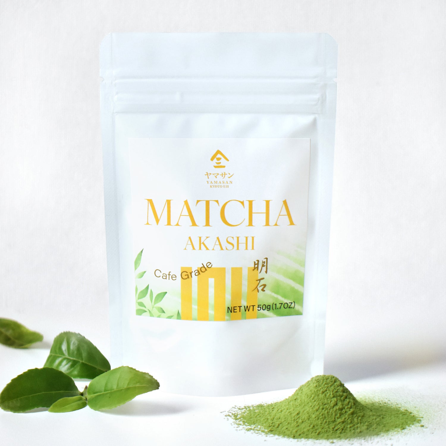 Matcha Akashi packaging with green leaves and matcha powder on a white background