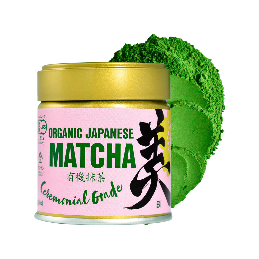 Jar of organic Japanese matcha green tea powder with a gold lid and pink label.