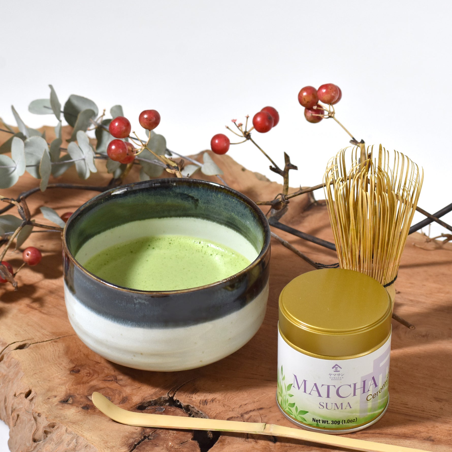 Matcha green tea bowl with Suma matcha canister on a wooden surface