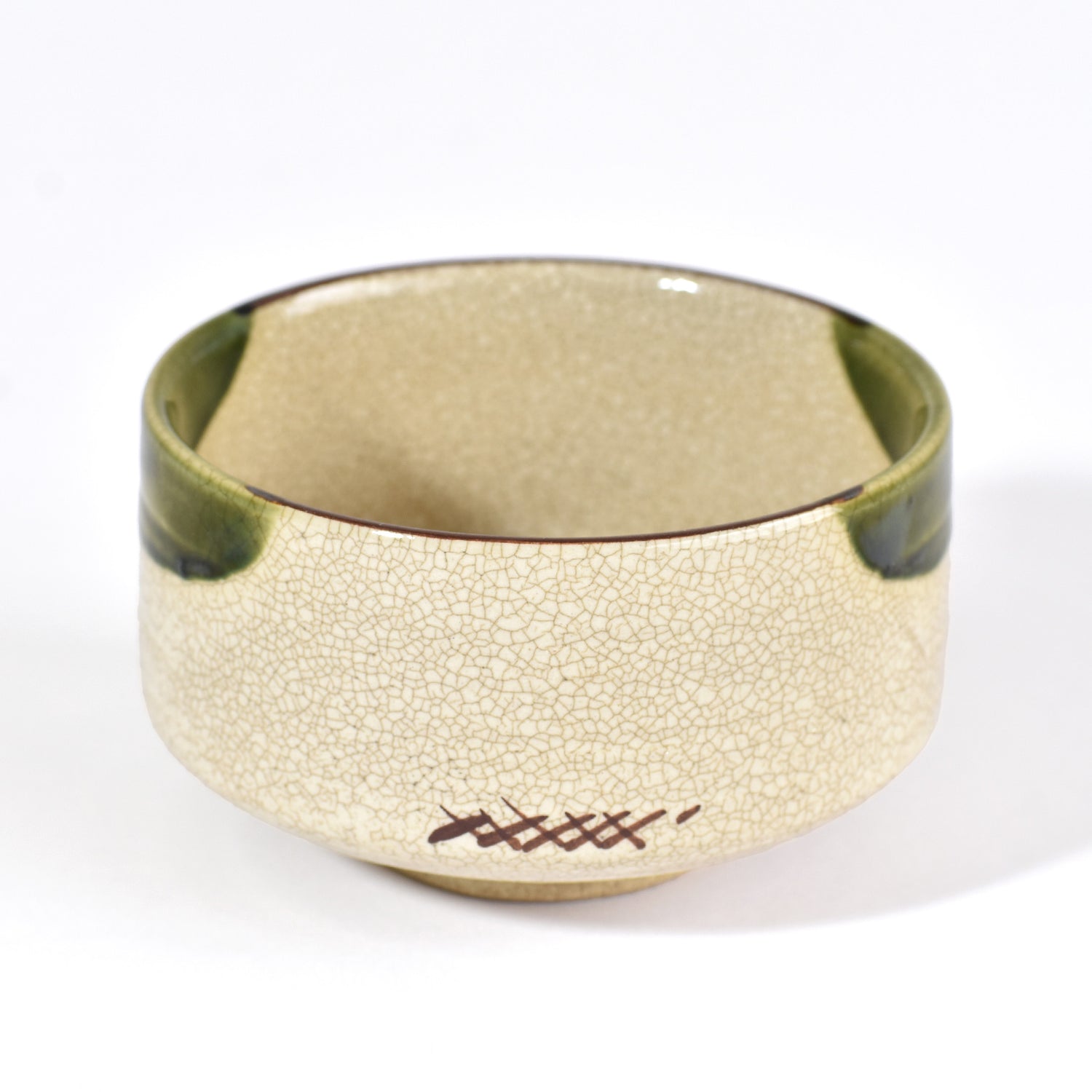 Gold bracelet with textured surface and green accents on a white background
