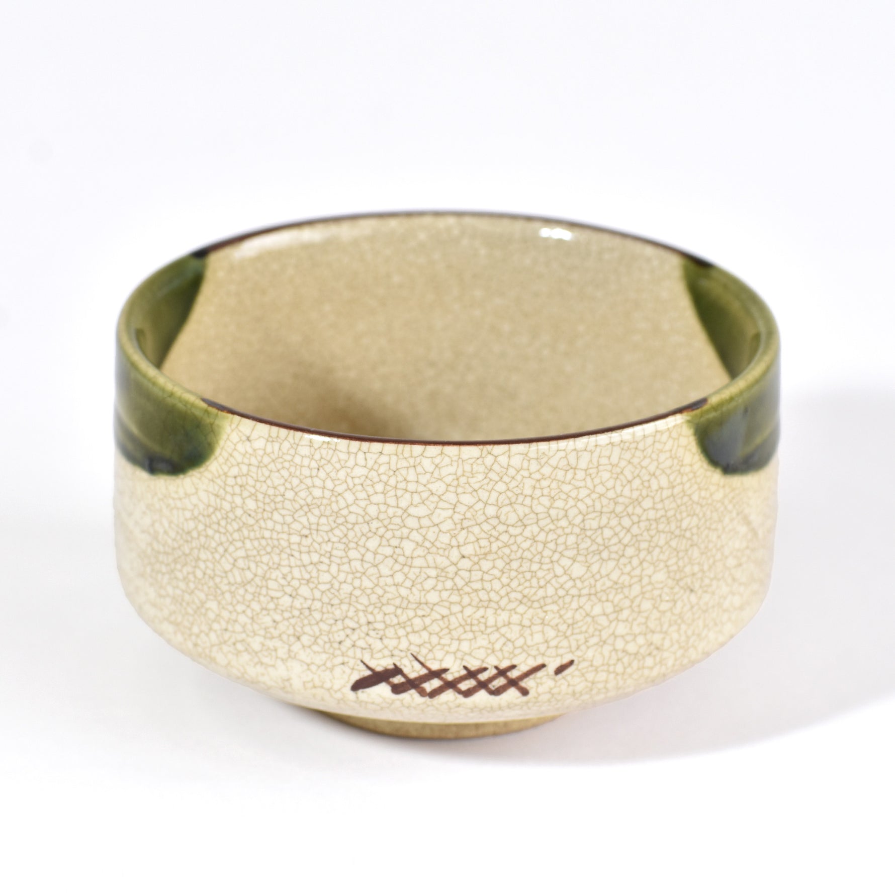 Gold bracelet with textured surface and green accents on a white background