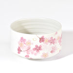 Ceramic bowl with pink floral pattern on a white background