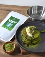Matcha green tea dessert with Uji Matcha Usidori packaging on a wooden surface.