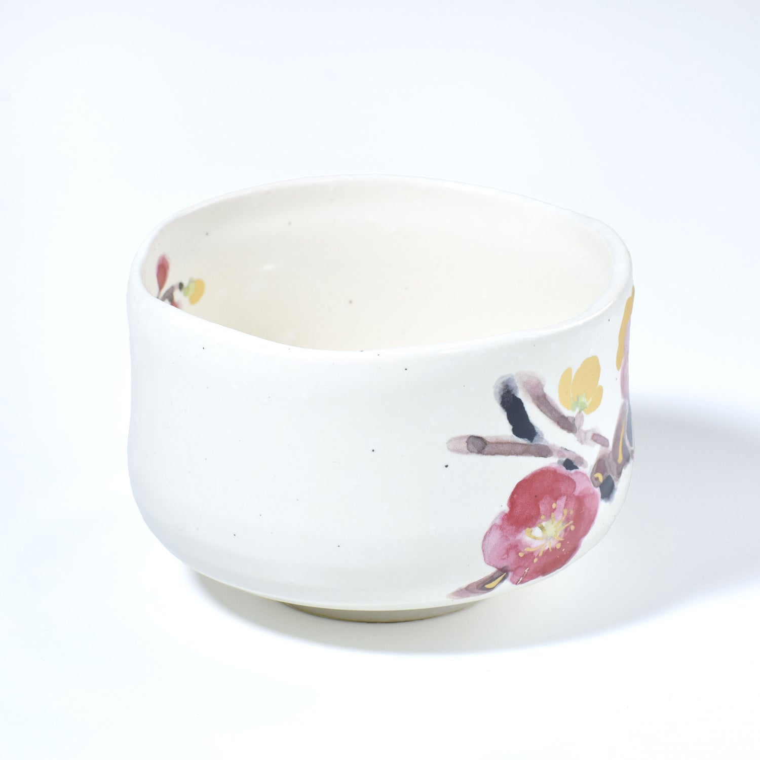 White ceramic bowl with floral design on a white background