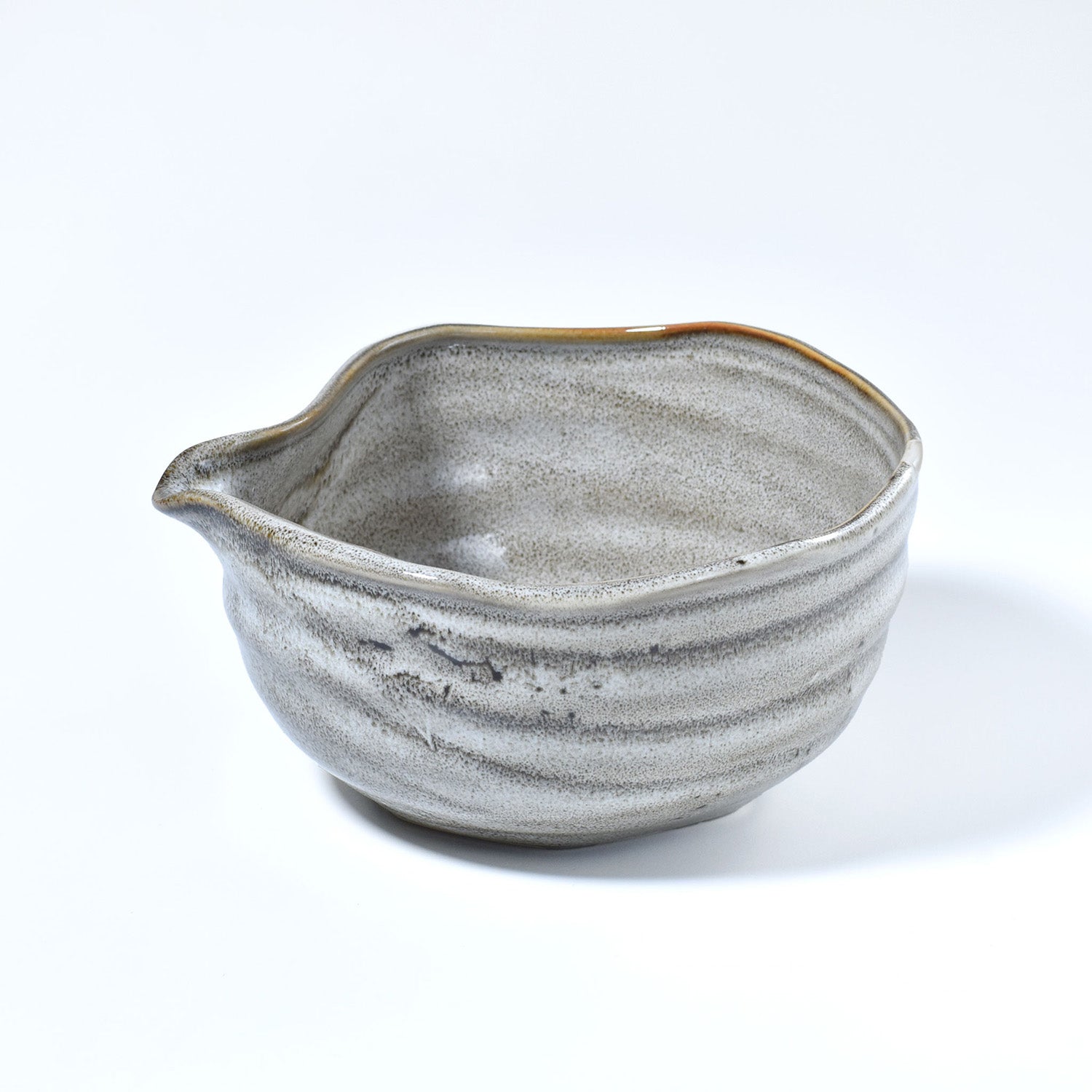 Gray ceramic matcha bowl with a unique texture on a white background
