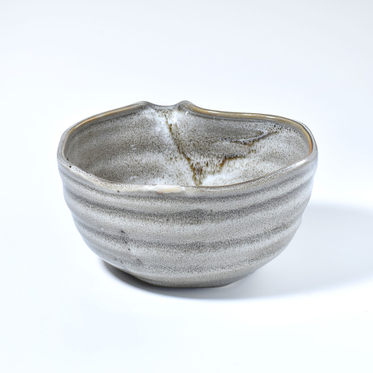 Gray ceramic matcha bowl with a unique texture on a white background