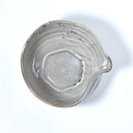 Gray ceramic matcha bowl with a unique texture on a white background