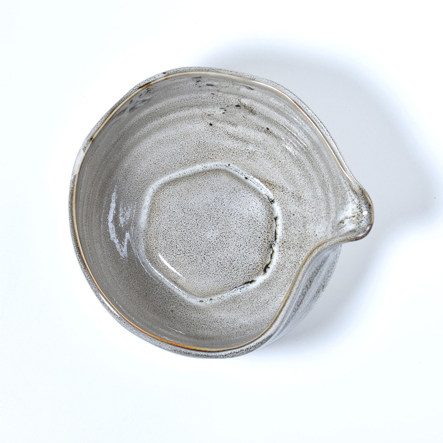 Gray ceramic matcha bowl with a unique texture on a white background
