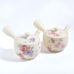 Two ceramic pots with floral designs on a white background